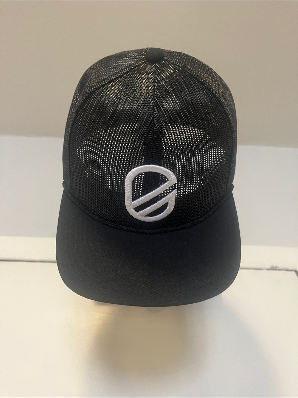 Extracurricular Black Mesh Trucker Cap with White Embroidered Logo